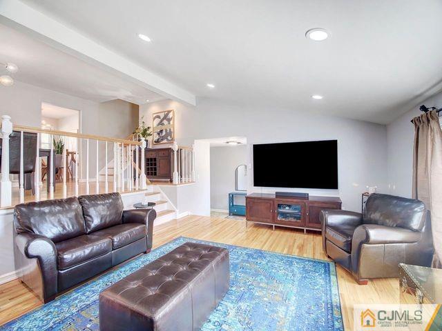 33 Thomas Road East Brunswick, NJ 08816 - Photo 6 of 28 a living room with furniture and a flat screen tv