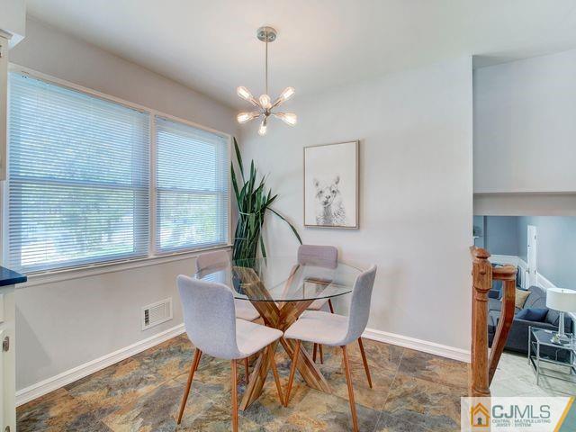 33 Thomas Road East Brunswick, NJ 08816 - Photo 10 of 28 a dining room with furniture a chandelier and window