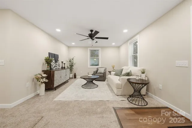 a living room with furniture and white walls