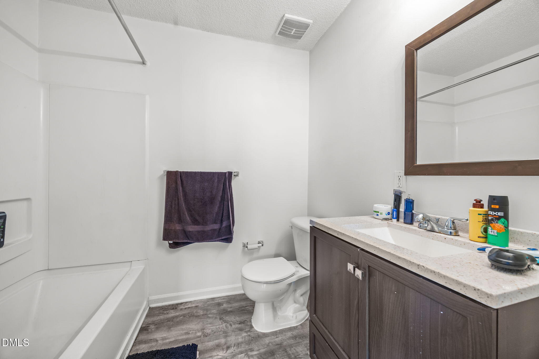 1305 Kent Road, Unit 101 Raleigh, NC 27606 - Photo 16 of 29 a bathroom with a sink a toilet and a bathtub
