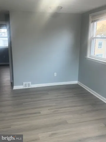a view of wooden floor and windows in a room