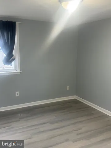 a room with wooden floor and window