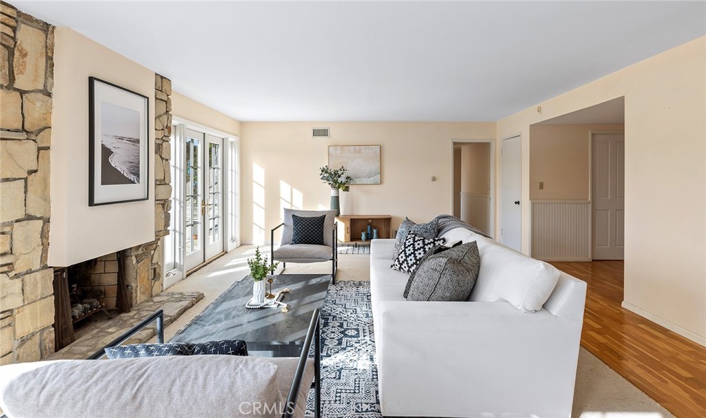 215 Via Montego San Clemente, CA 92672 - Photo 23 of 69 a living room with furniture potted plant and a wooden floor