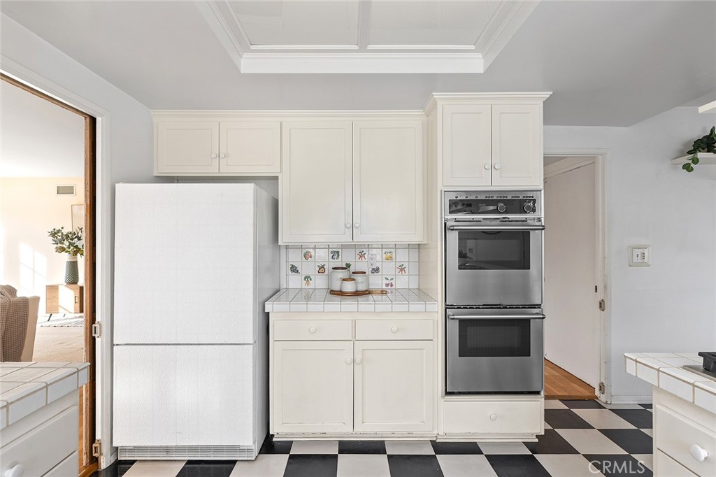 215 Via Montego San Clemente, CA 92672 - Photo 29 of 69 a white refrigerator freezer and a stove sitting inside of a kitchen