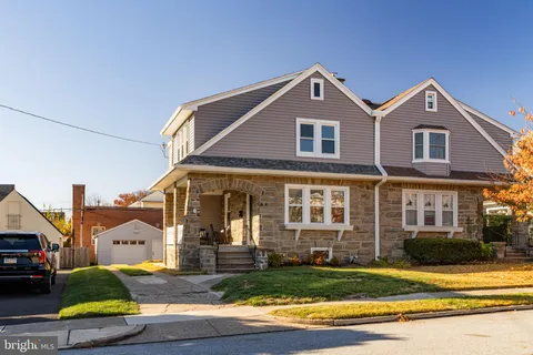 a view of a brick house with many windows and yard