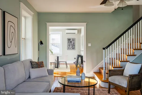 a living room with furniture and a wooden floor