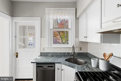 a kitchen with a sink and a stove top oven