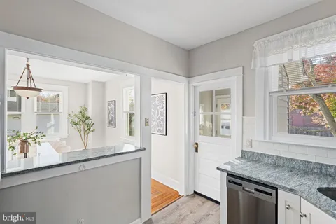 a hallway with sink and mirror
