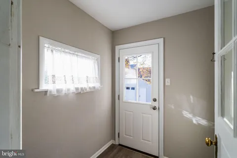 a view of a hallway with closet and wooden floor