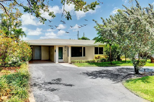 a front view of a house with garden and porch