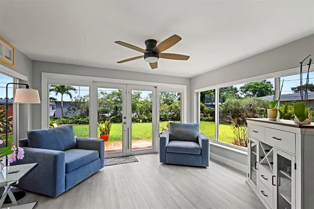 a living room with furniture and a large window