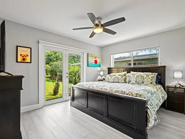 a bedroom with a bed and a large window