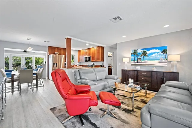 a living room with furniture a rug and a flat screen tv