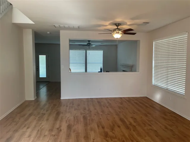 a view of a livingroom with a ceiling fan and window