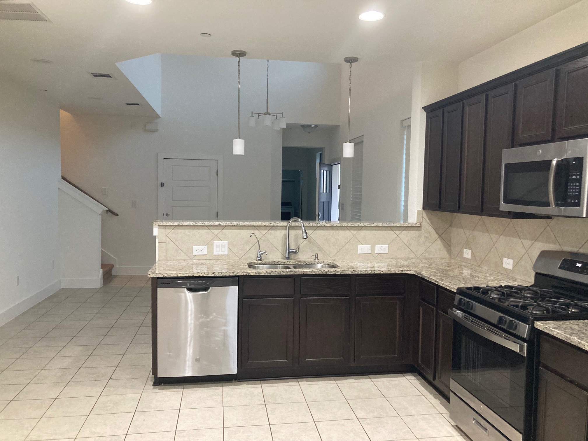 12410 Maypole Bend Austin, TX 78717 - Photo 11 of 32 a kitchen with a sink and a stove top oven