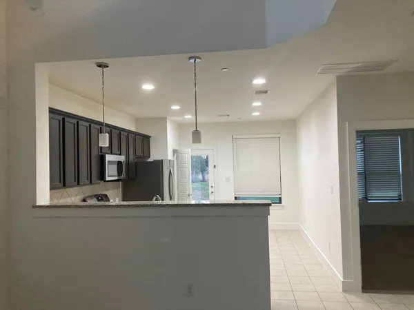 a view of a kitchen with a sink and refrigerator
