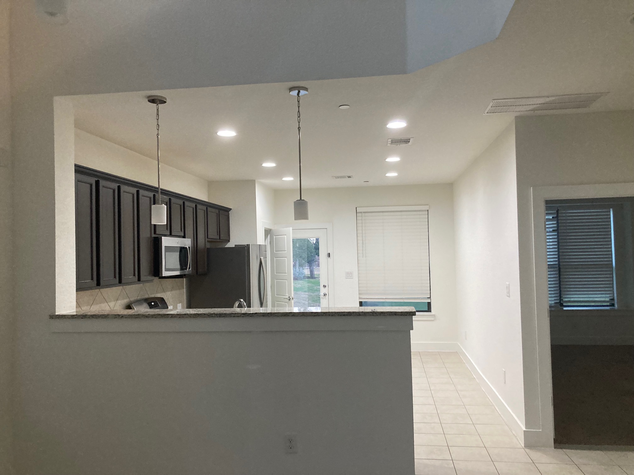 12410 Maypole Bend Austin, TX 78717 - Photo 13 of 32 a view of a kitchen with a sink and a refrigerator