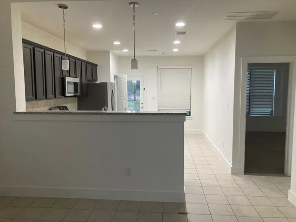 a view of a kitchen with kitchen island