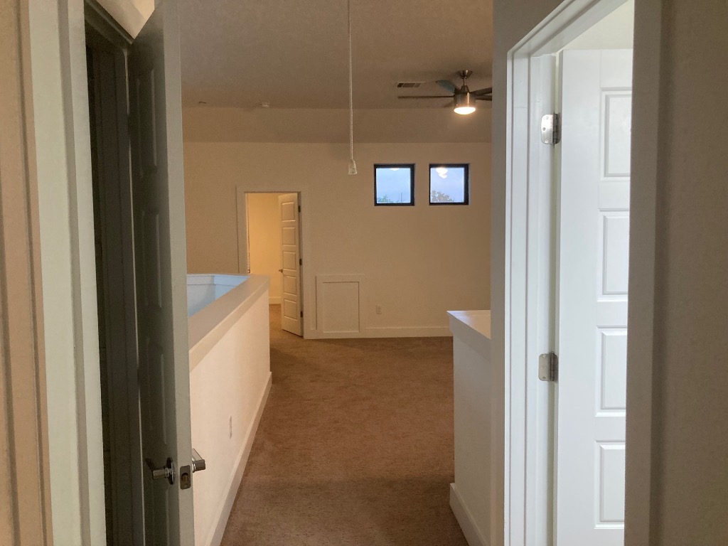 12410 Maypole Bend, Unit 1401 Austin, TX 78717 - Photo 29 of 32 a view of a bathroom from a hallway
