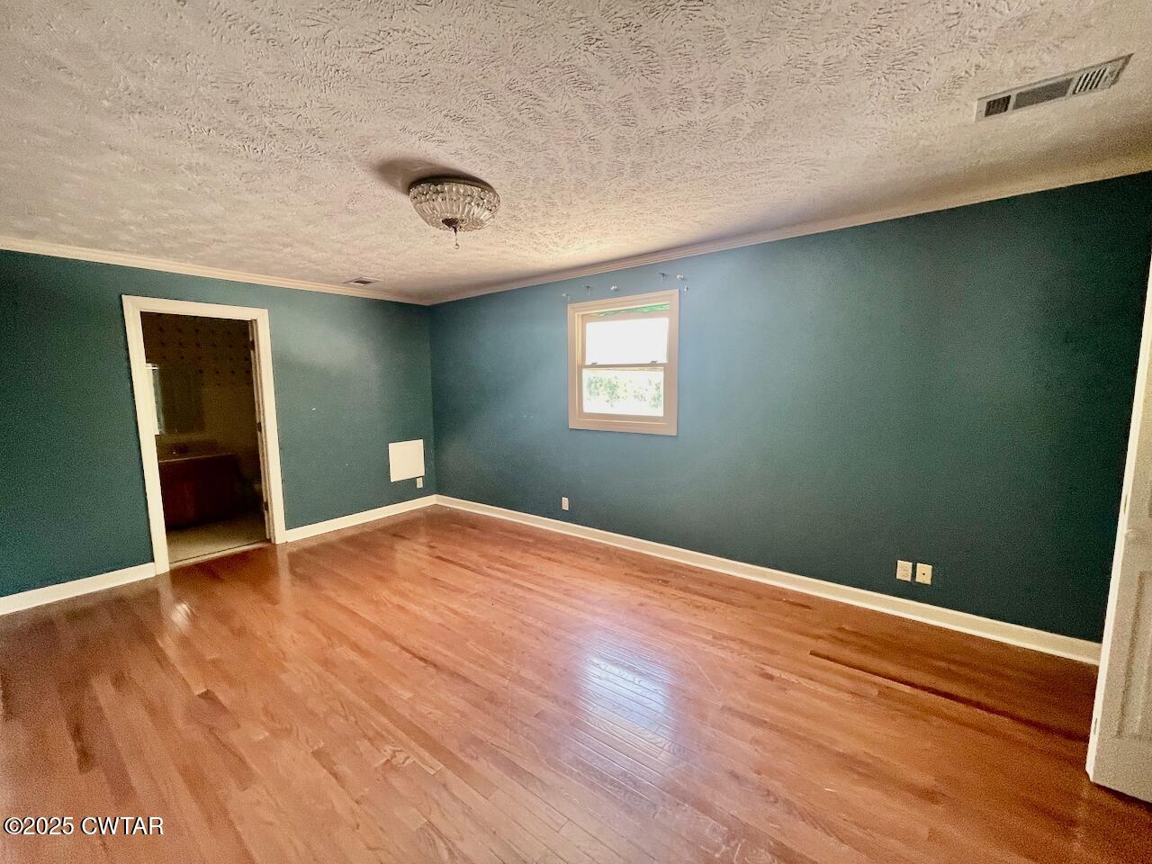 2688 Beech Bluff Road Jackson, TN 38301 - Photo 19 of 30 an empty room with wooden floor and windows