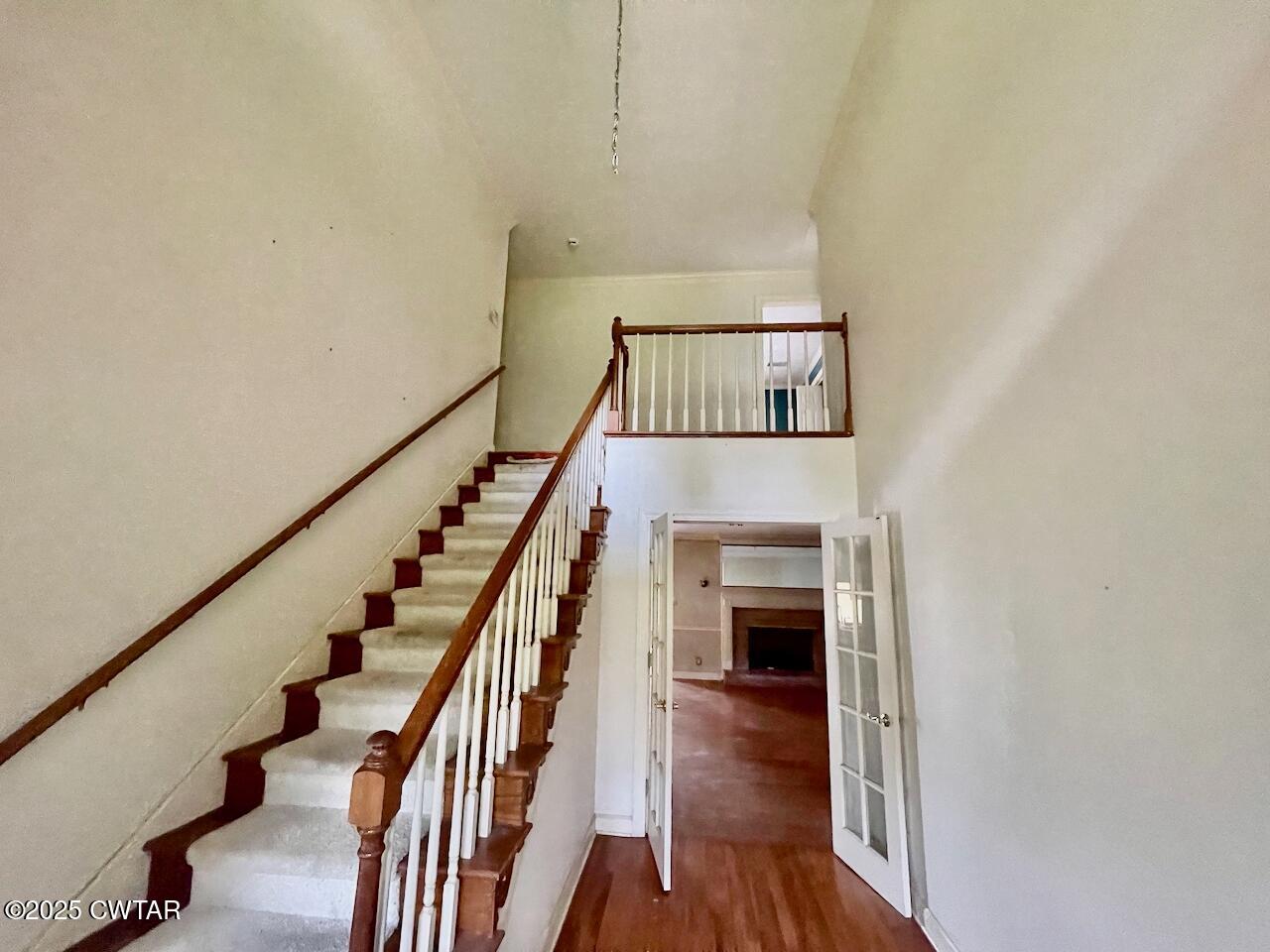 2688 Beech Bluff Road Jackson, TN 38301 - Photo 4 of 30 a view of staircase with wooden floor and a floor to ceiling window