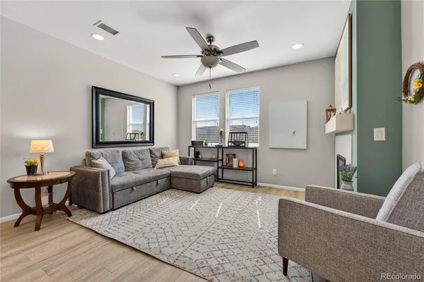 a living room with furniture and a wooden floor