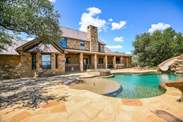 a front view of a house with swimming pool and porch
