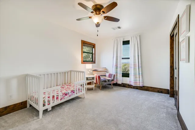 a bedroom with bed and a chandelier