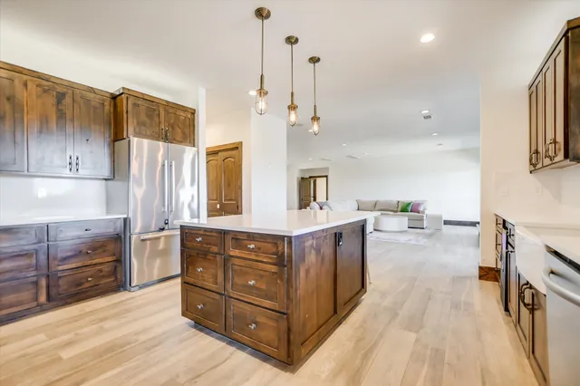 a kitchen with stainless steel appliances granite countertop a stove and a refrigerator