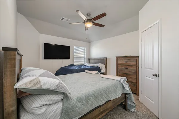 a bedroom with a bed and a television
