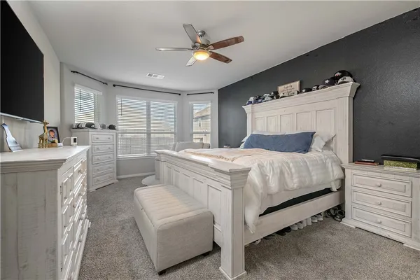 a bed room with a bed and a television