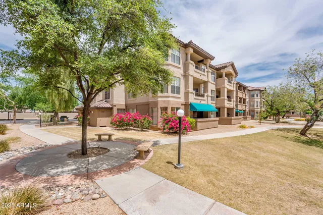 a park with trees and sign board
