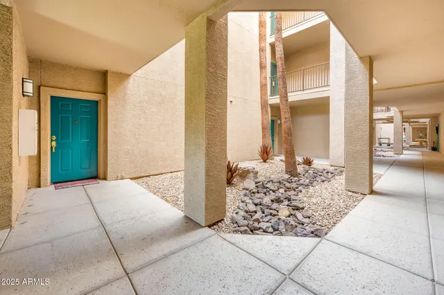 a view of a house with a wooden bench