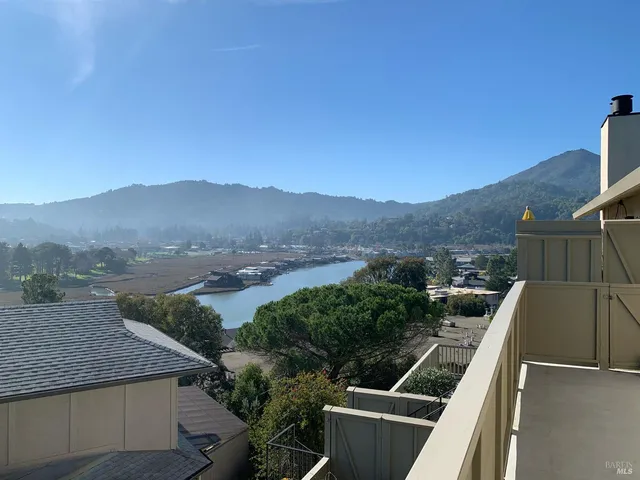 a view of a balcony with mountain view and wooden floor