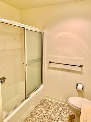 a bathroom with a shower and a toilet