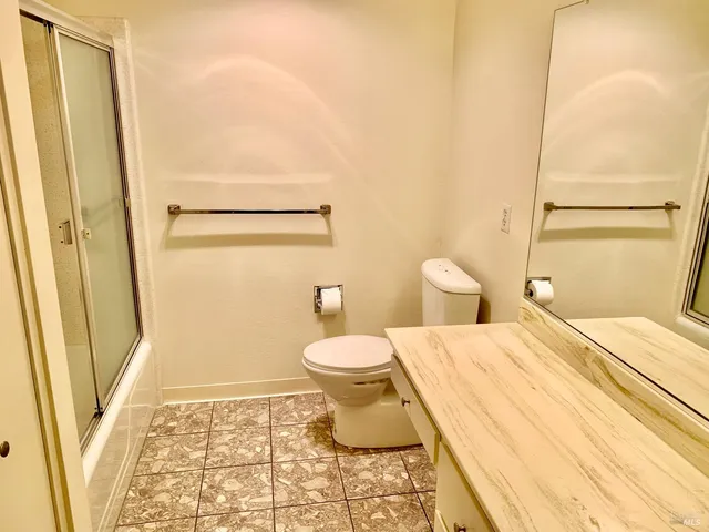 a bathroom with a toilet and a shower