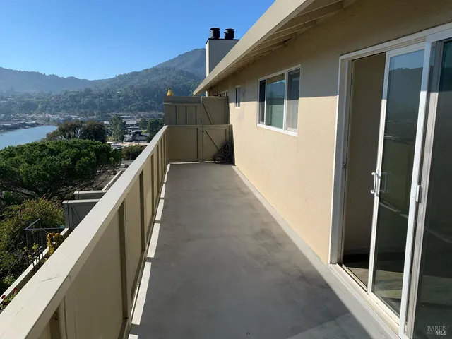 a view of a balcony with mountain view and wooden floor