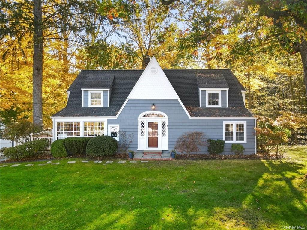 a front view of house with yard and green space