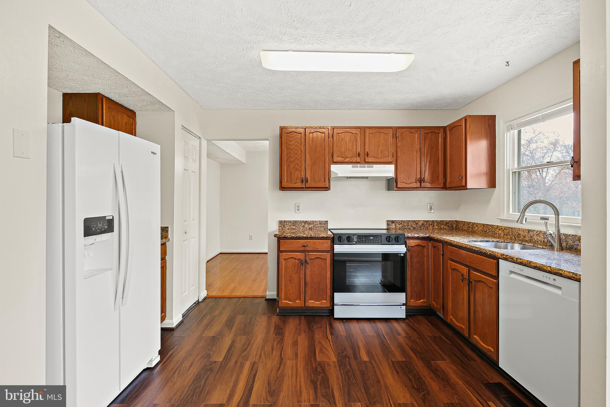 3 Greenknoll Boulevard Hanover, MD 21076 - Photo 13 of 34 a kitchen with stainless steel appliances granite countertop a stove and a refrigerator