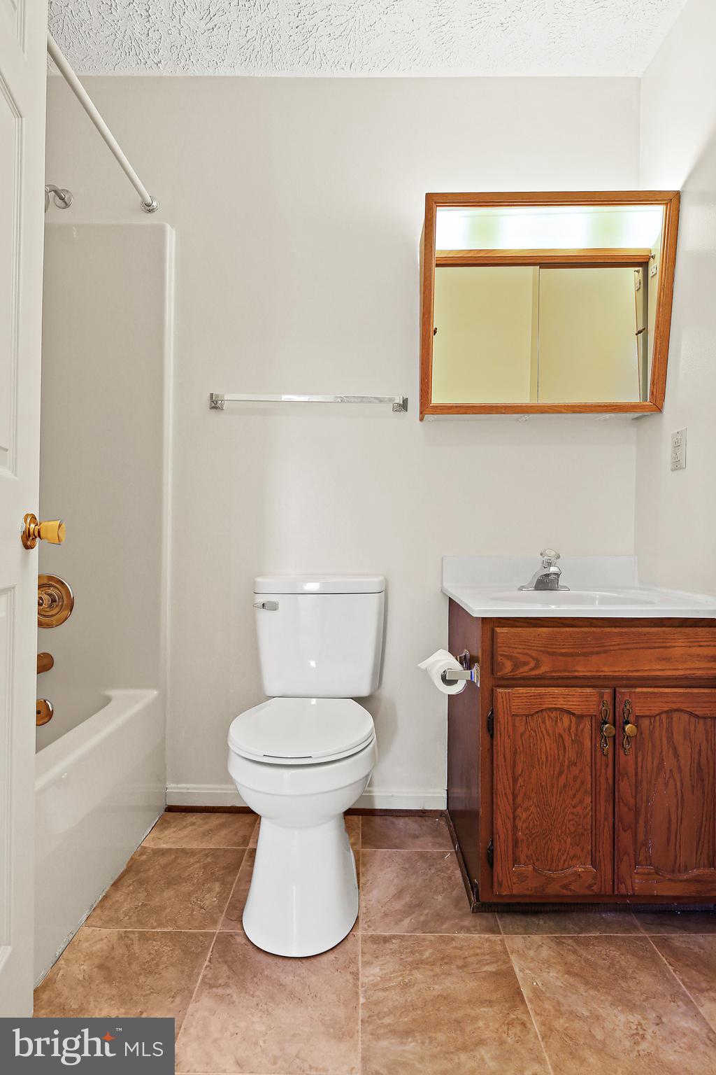 3 Greenknoll Boulevard Hanover, MD 21076 - Photo 28 of 34 a bathroom with a toilet sink and mirror