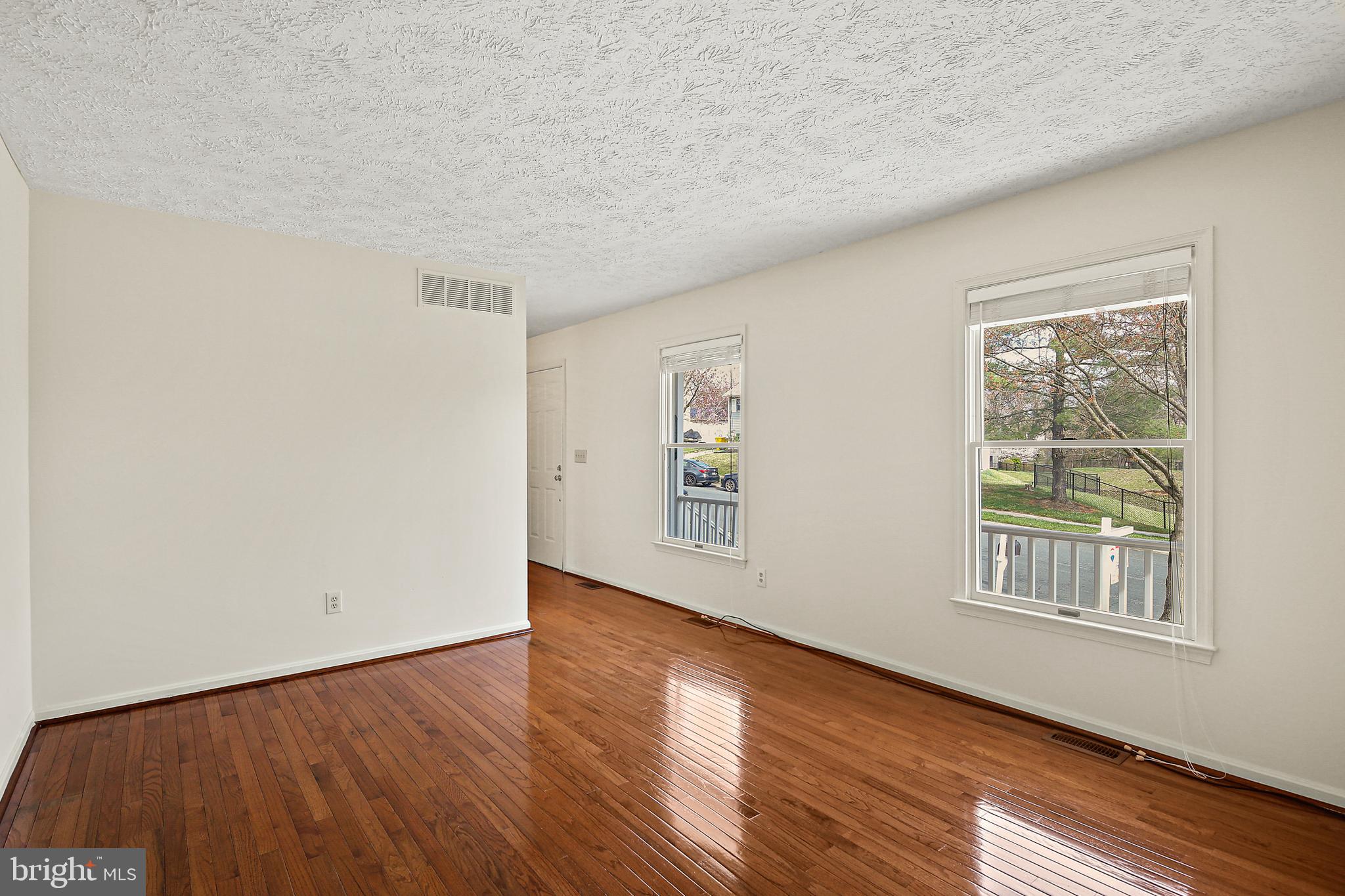 3 Greenknoll Boulevard Hanover, MD 21076 - Photo 5 of 34 an empty room with wooden floor and windows