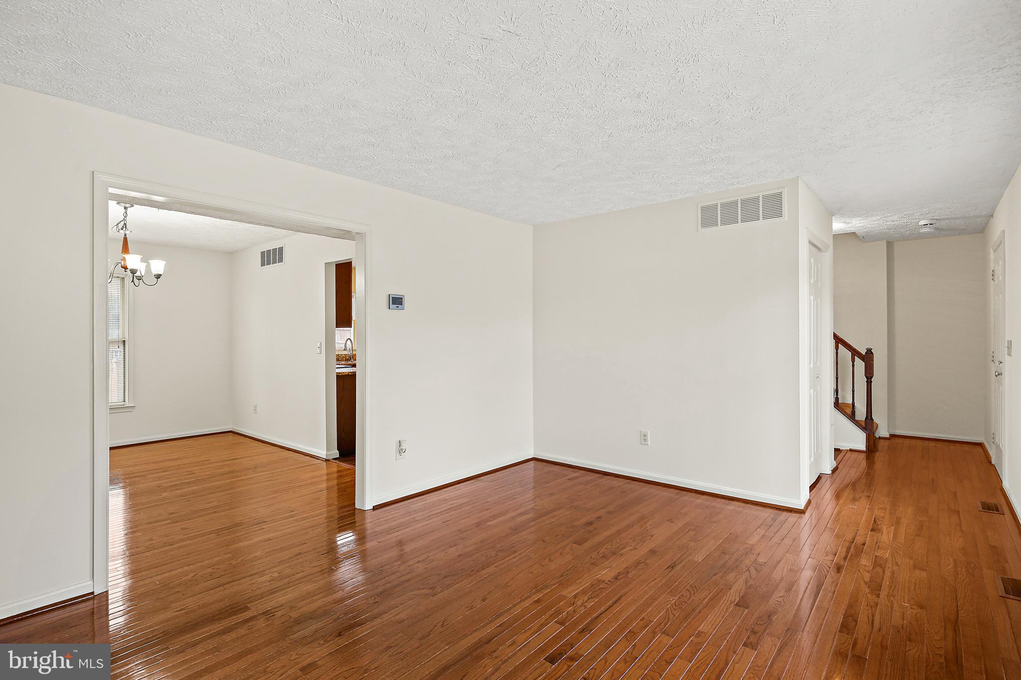 3 Greenknoll Boulevard Hanover, MD 21076 - Photo 6 of 34 a view of an empty room with wooden floor and a window