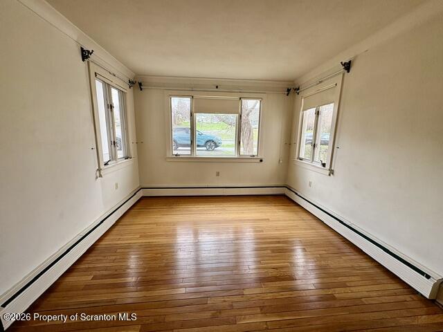 706 Delaware Street Forest City, PA 18421 - Photo 7 of 33 an empty room with wooden floor and windows