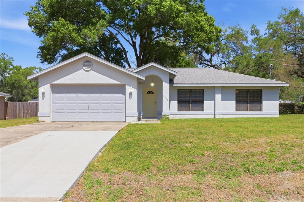 6355 East Rush Street Inverness, FL 34452 - Photo 1 of 27 a front view of a house with a garden and porch