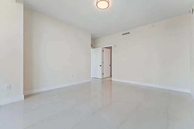 a view of an empty room with windows