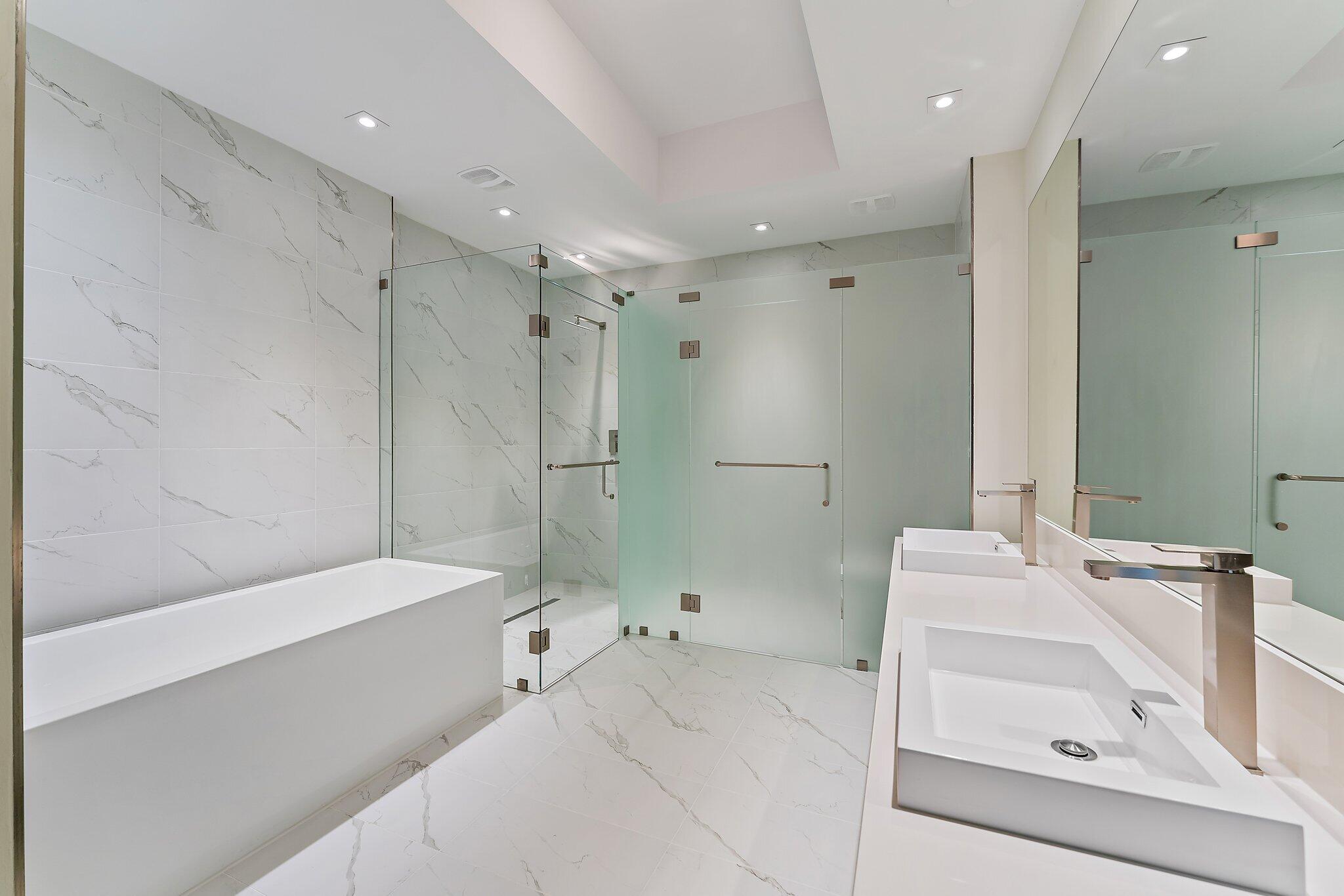 3100 North Ocean Drive, Unit H1206 Singer Island, FL 33404 - Photo 20 of 78 a bathroom with a bathtub a sink a toilet and a mirror