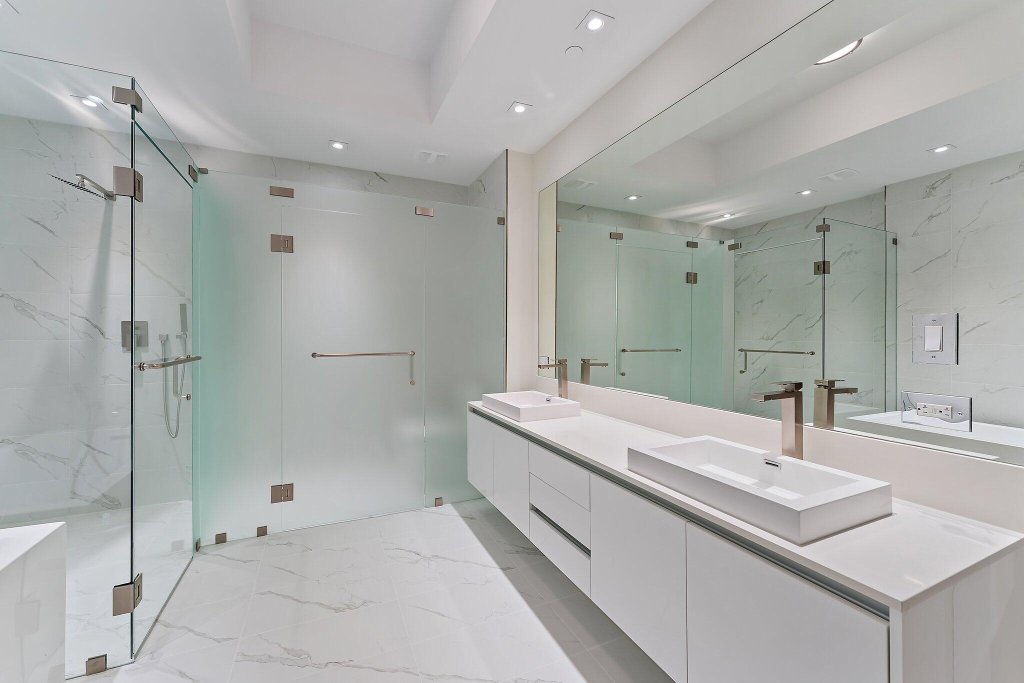 3100 North Ocean Drive, Unit H1206 Singer Island, FL 33404 - Photo 21 of 78 a bathroom with a double vanity sink mirror and shower