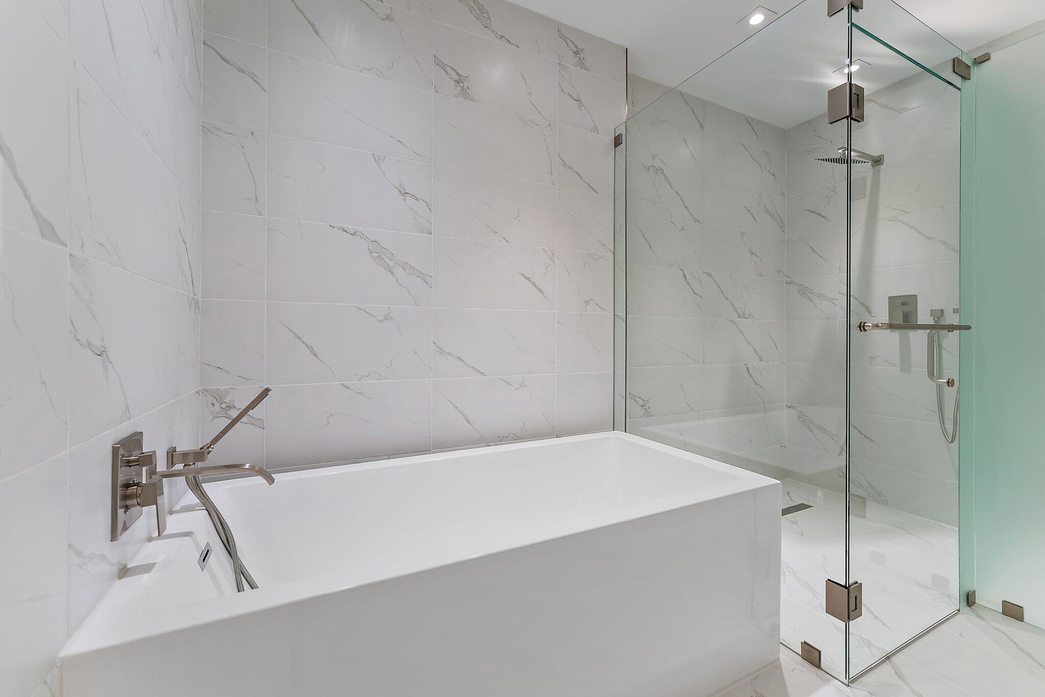 3100 North Ocean Drive, Unit H1206 Singer Island, FL 33404 - Photo 22 of 78 a bathroom with a bathtub and a shower