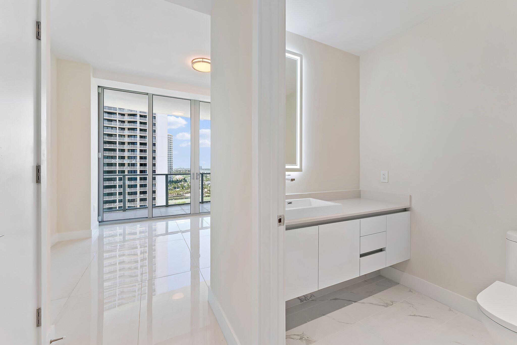 3100 North Ocean Drive, Unit H1206 Singer Island, FL 33404 - Photo 29 of 78 a bathroom with a sink a toilet and shower