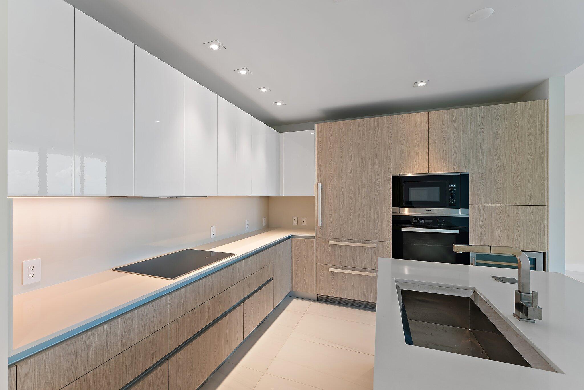 3100 North Ocean Drive, Unit H1206 Singer Island, FL 33404 - Photo 3 of 78 a kitchen with a sink and a stove top oven